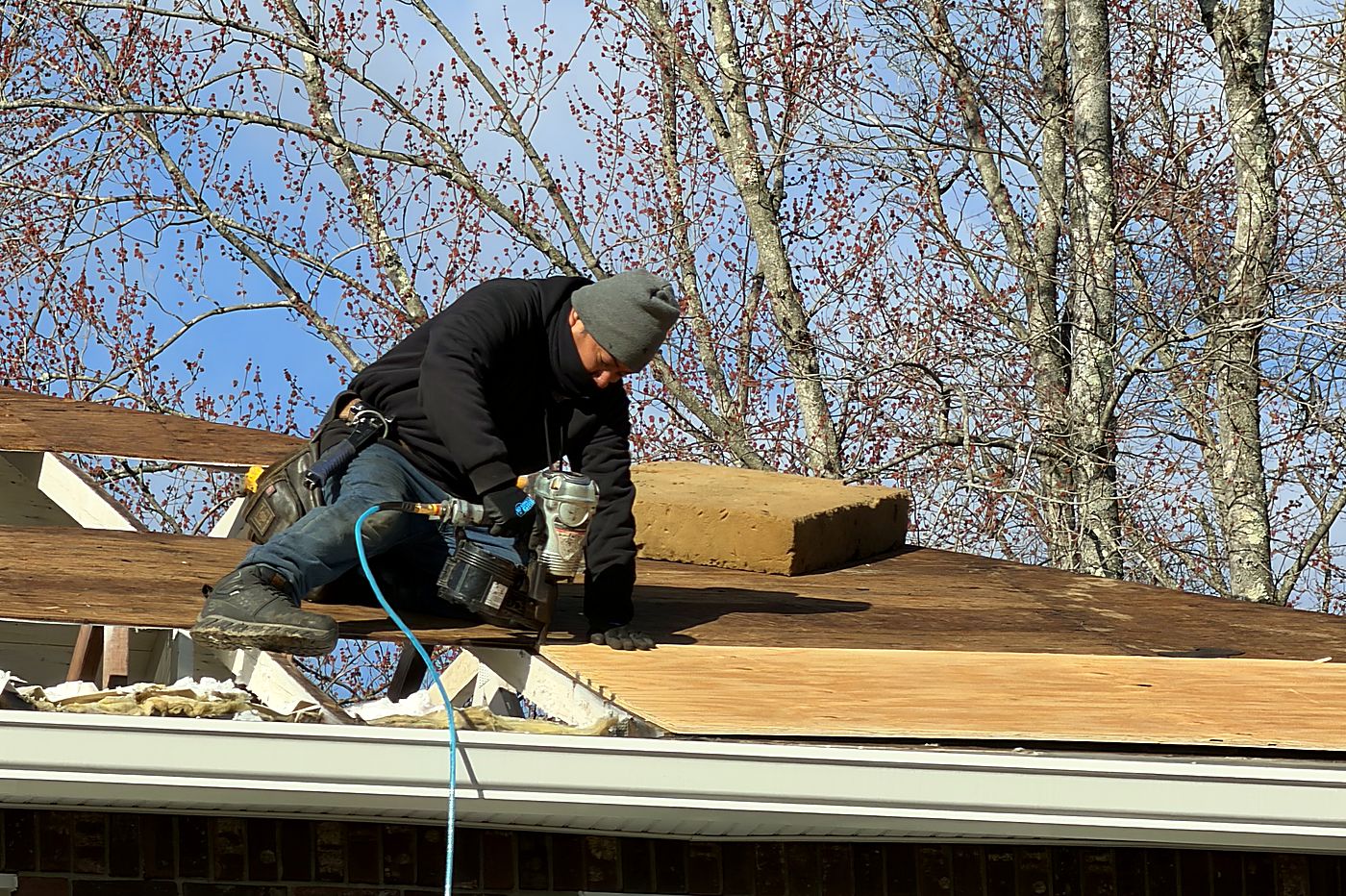 Decking replacement — Rotted sheathing cut out and replaced before underlayment.