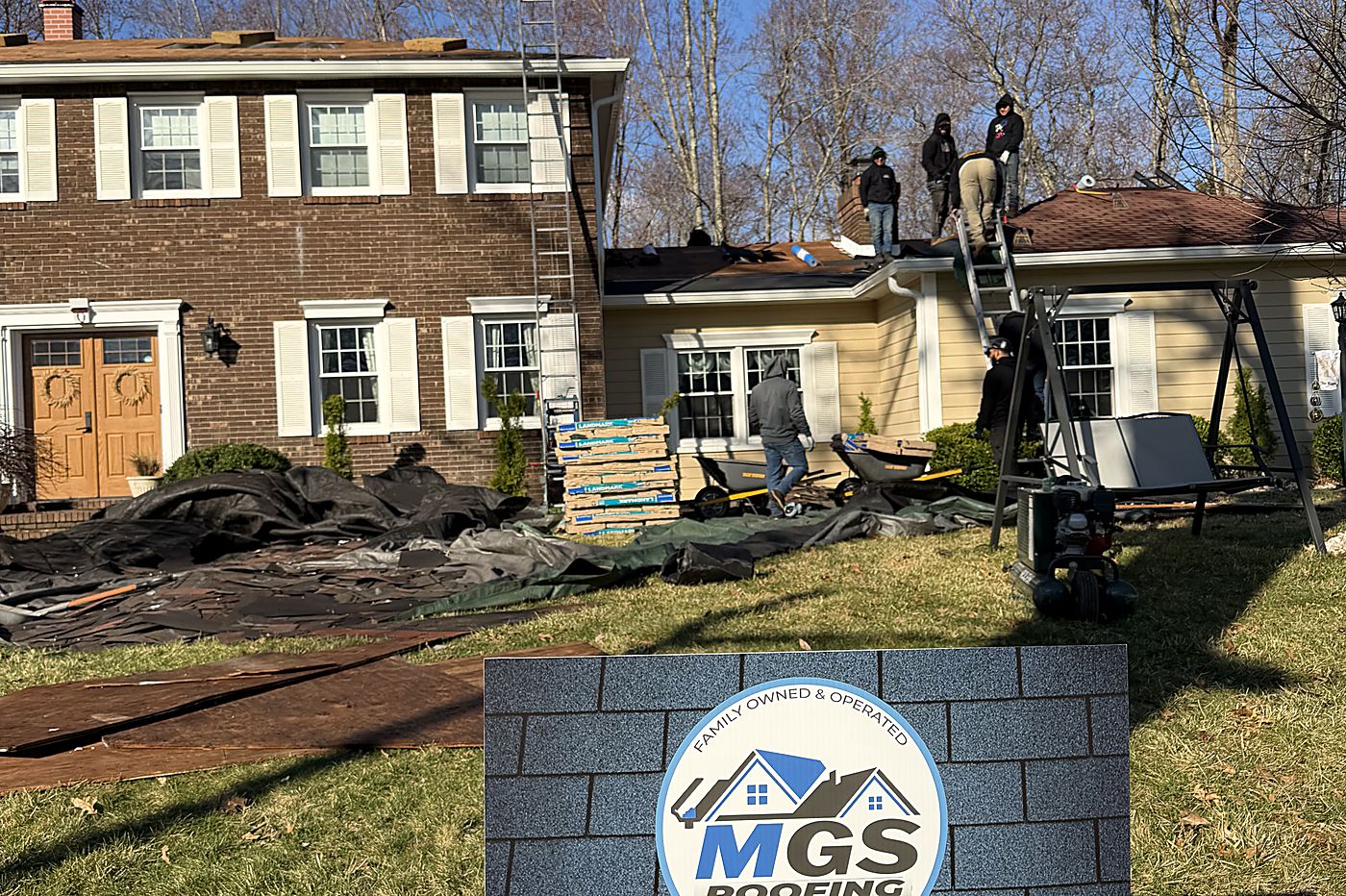 Tear-off underway — Old shingles stripped, landscaping tarped and protected.
